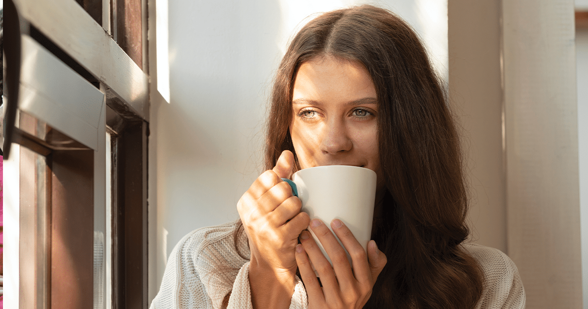 woman suffering from seasonal affective disorder in Alaska sipping from a mug