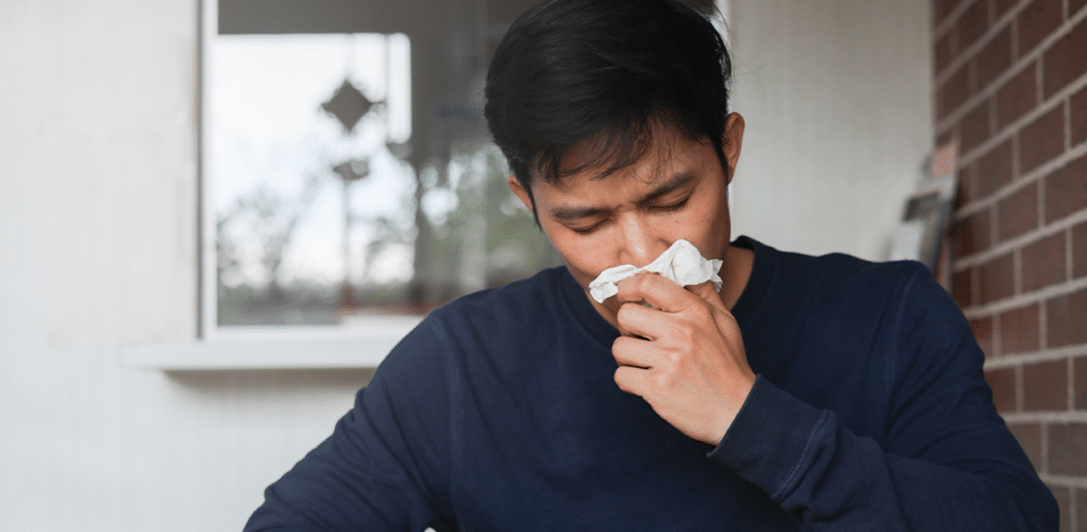 Man blowing his nose.