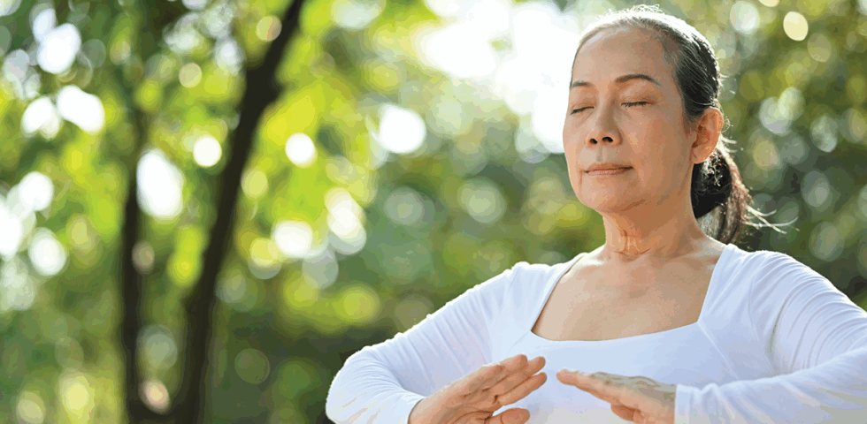 Woman meditating outside.