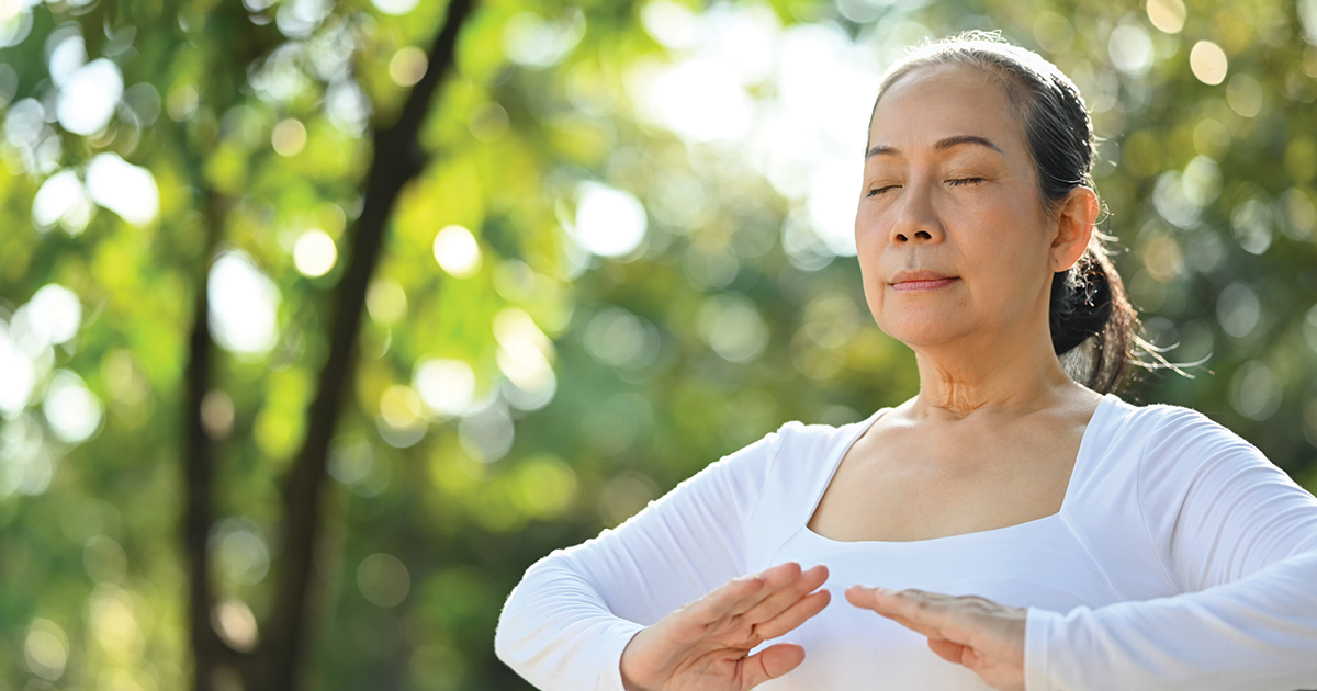 Woman meditating outside.